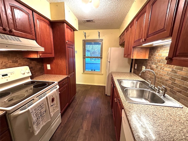 kitchen with sink, dark hardwood / wood-style flooring, range hood, a textured ceiling, and white appliances