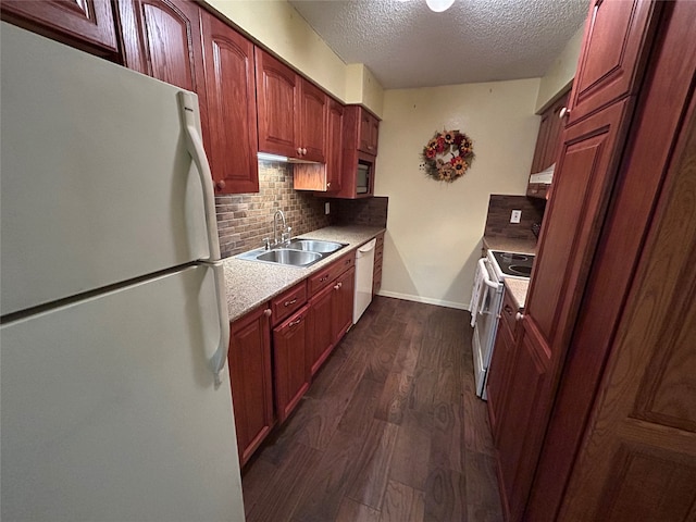 kitchen featuring sink, dark hardwood / wood-style floors, a textured ceiling, white appliances, and decorative backsplash