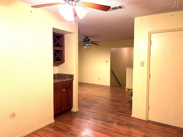 empty room featuring dark hardwood / wood-style flooring and a textured ceiling