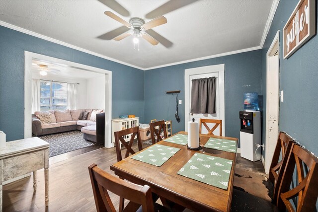 dining room featuring dark hardwood / wood-style floors, ceiling fan, and crown molding