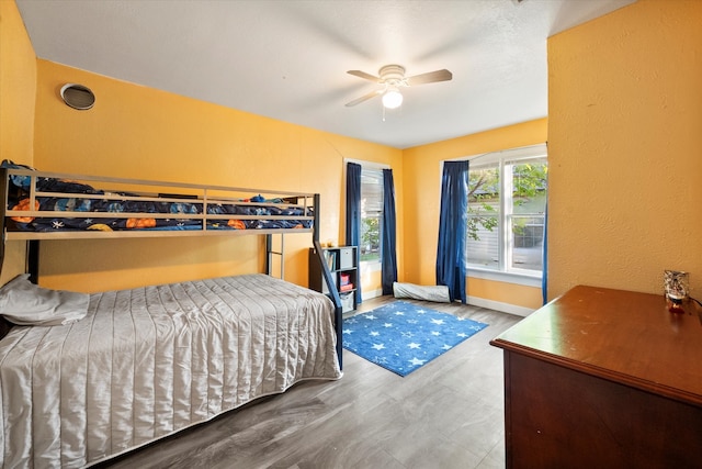 bedroom with hardwood / wood-style floors and ceiling fan