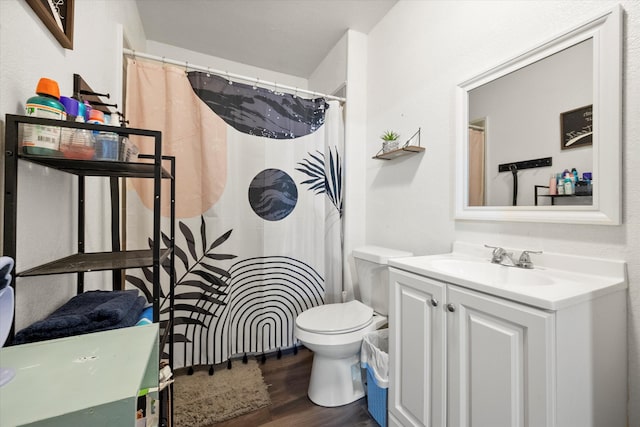 bathroom featuring hardwood / wood-style floors, vanity, and toilet