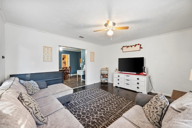 living room with ceiling fan, dark hardwood / wood-style floors, and ornamental molding