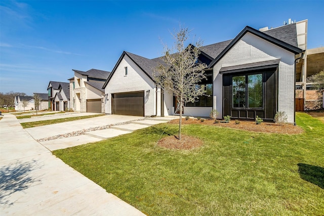 view of front of property with a garage and a front lawn