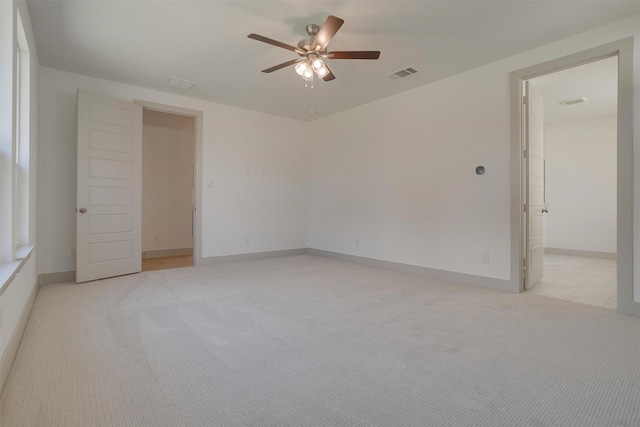 carpeted empty room featuring ceiling fan