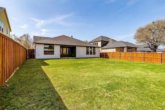 rear view of property with a yard