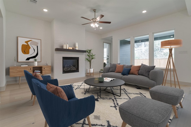 living room featuring ceiling fan and light wood-type flooring