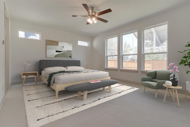 bedroom featuring multiple windows, light colored carpet, and ceiling fan