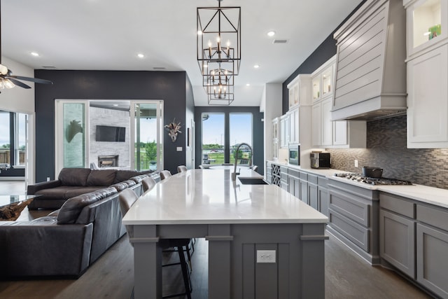 2608 Camden Ct, Celina, TX 75009 - kitchen featuring a sink, open floor plan, custom range hood, gray cabinets, and gas cooktop