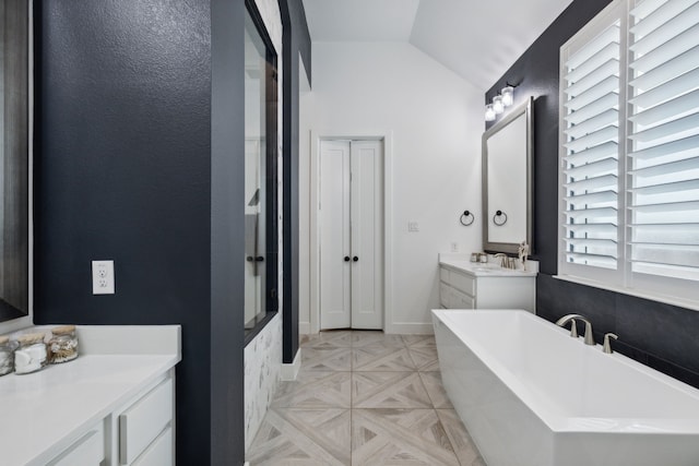 2608 Camden Ct, Celina, TX 75009 - bathroom with a freestanding tub, vanity, and lofted ceiling