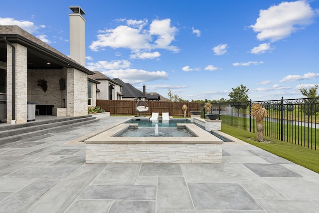 2608 Camden Ct, Celina, TX 75009 - fenced backyard featuring a fireplace and a patio area
