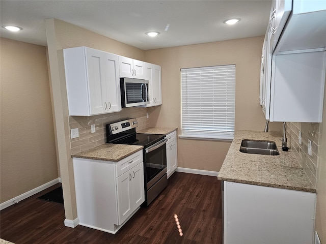 kitchen with white cabinets, stainless steel appliances, dark hardwood / wood-style floors, and sink