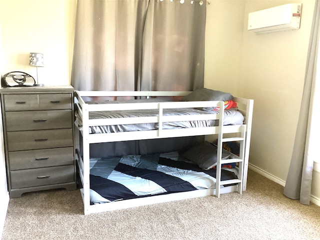 carpeted bedroom featuring an AC wall unit