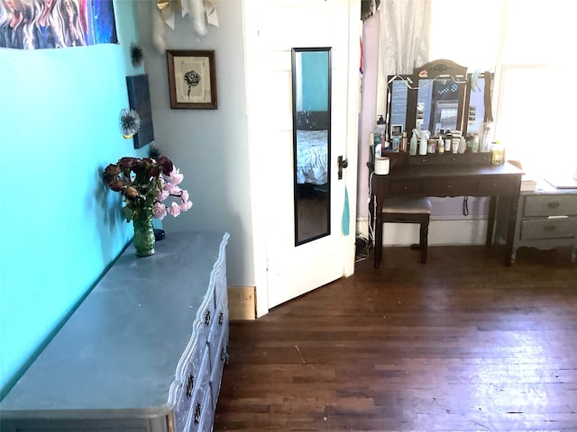 hallway with dark hardwood / wood-style flooring