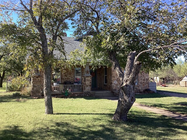 obstructed view of property featuring a front lawn