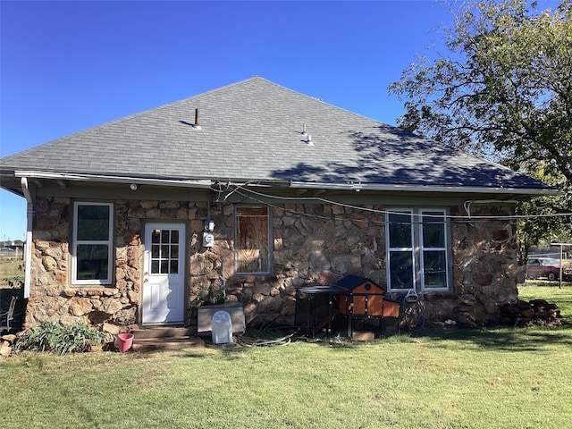 rear view of property with a yard