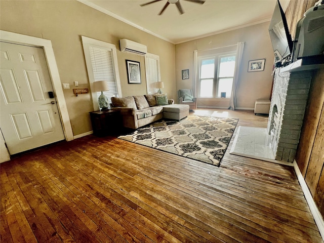 living room featuring crown molding, wood-type flooring, a wall mounted air conditioner, and a brick fireplace