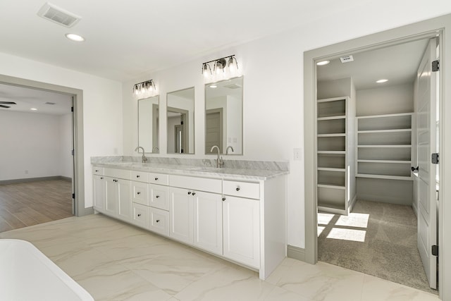 full bathroom with marble finish floor, double vanity, recessed lighting, visible vents, and a sink