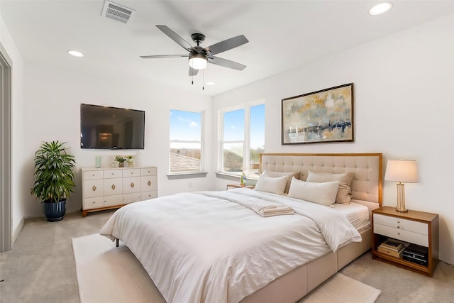 carpeted bedroom featuring ceiling fan, visible vents, and recessed lighting