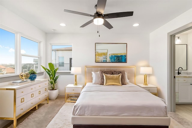 bedroom featuring a ceiling fan, ensuite bathroom, a sink, and recessed lighting