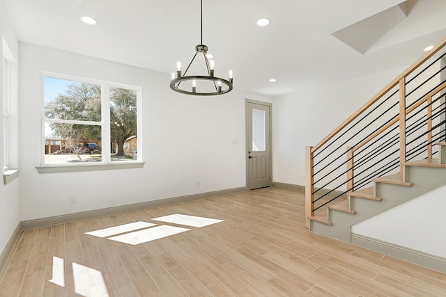 interior space featuring baseboards, wood finished floors, stairs, a chandelier, and recessed lighting