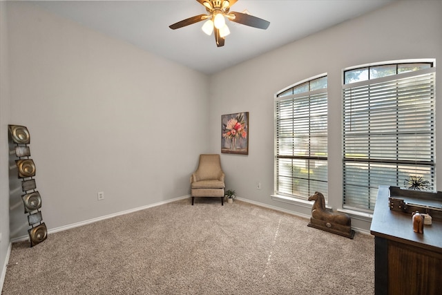 living room with ceiling fan and carpet