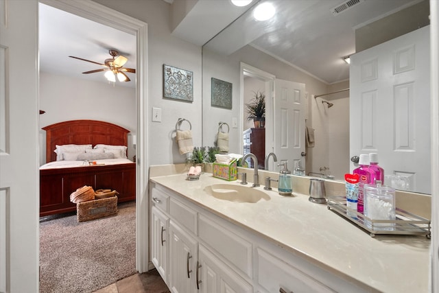 bathroom with vanity, ceiling fan, and curtained shower