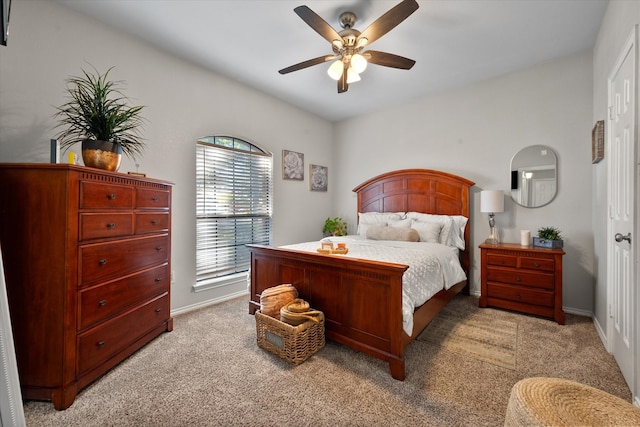 bedroom with ceiling fan, dark wood-type flooring, and a tray ceiling