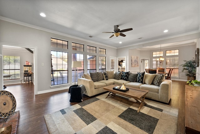 living room with ceiling fan with notable chandelier, dark hardwood / wood-style flooring, and ornamental molding