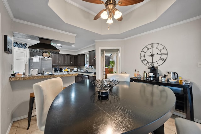 kitchen with exhaust hood, crown molding, appliances with stainless steel finishes, tasteful backsplash, and dark brown cabinetry