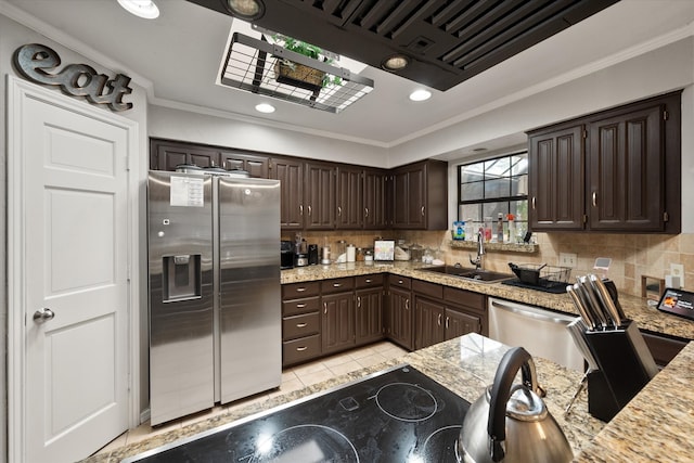 kitchen with black appliances, kitchen peninsula, crown molding, and exhaust hood