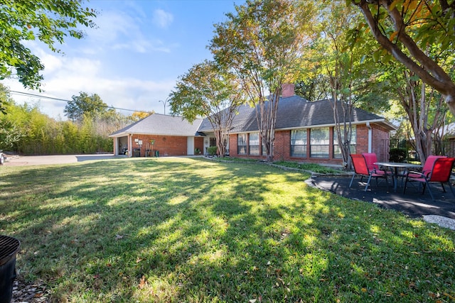 view of side of property featuring a garage and a lawn