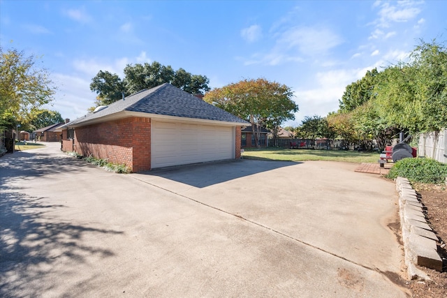 view of property exterior featuring a garage and a yard