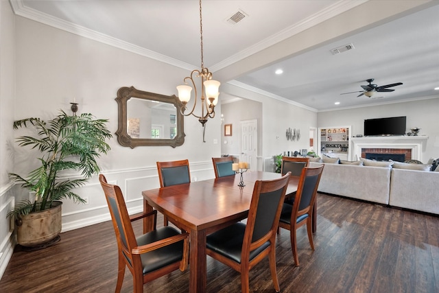 dining room featuring crown molding, dark hardwood / wood-style flooring, and a fireplace