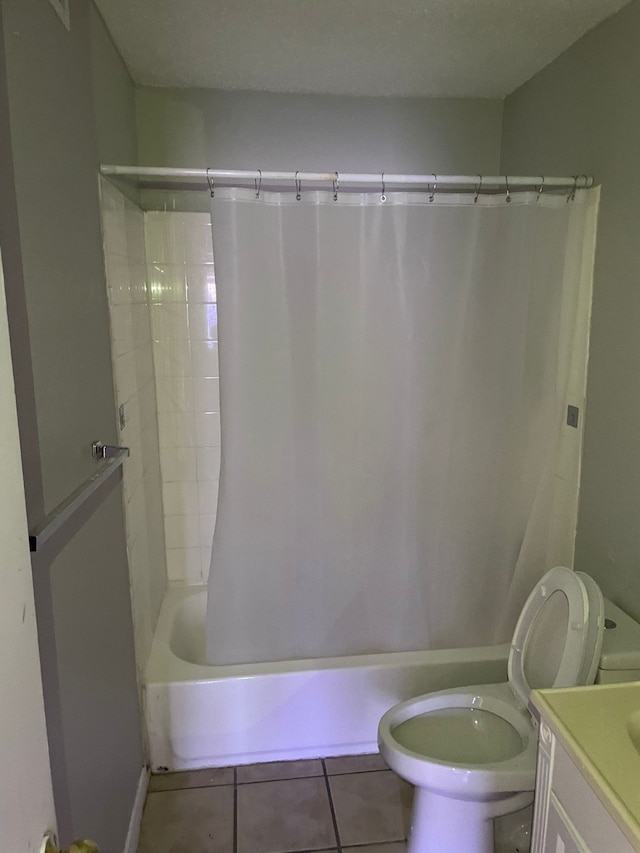 full bathroom with tile patterned flooring, vanity, a textured ceiling, and toilet