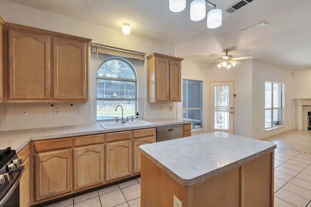 kitchen with ceiling fan, sink, tasteful backsplash, decorative light fixtures, and appliances with stainless steel finishes