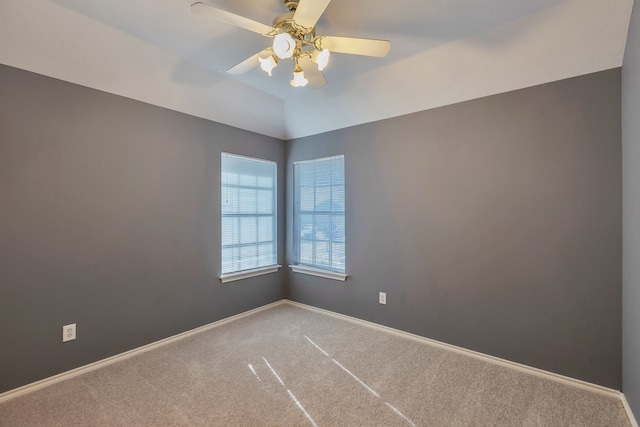 carpeted spare room featuring ceiling fan