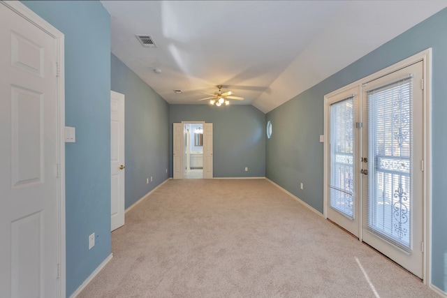 additional living space with ceiling fan, french doors, light carpet, and vaulted ceiling