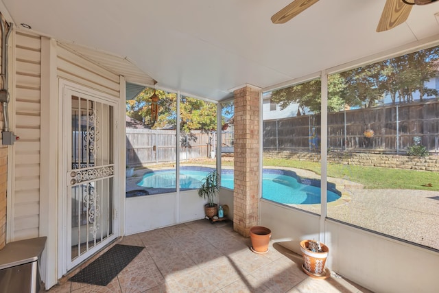 unfurnished sunroom featuring ceiling fan