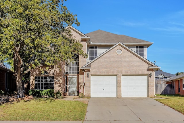 traditional-style house featuring a front lawn, fence, brick siding, and driveway