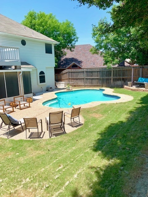 view of pool with a yard