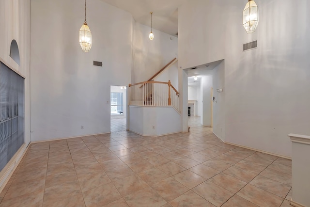 tiled empty room with a high ceiling