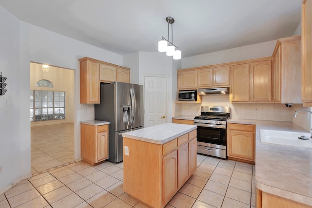 kitchen featuring a center island, sink, light brown cabinetry, appliances with stainless steel finishes, and decorative light fixtures