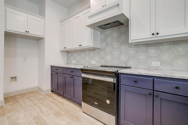 kitchen with light wood finished floors, electric range, under cabinet range hood, white cabinetry, and backsplash