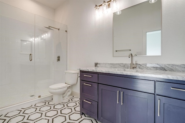 bathroom with vanity, an enclosed shower, and toilet