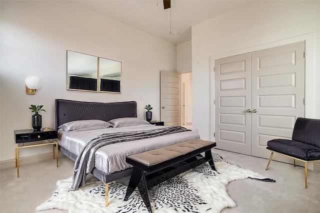 bedroom featuring a closet, light colored carpet, and baseboards