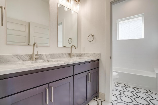 full bath with toilet, double vanity, bathtub / shower combination, and a sink