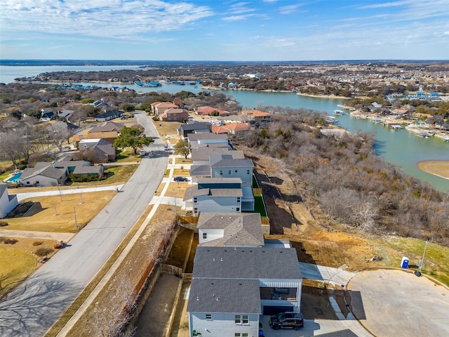 drone / aerial view featuring a residential view and a water view