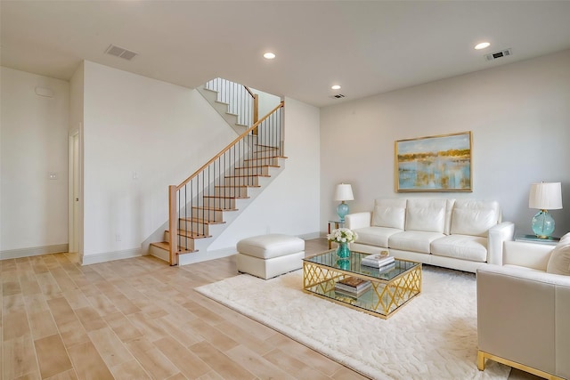 living room featuring stairs, recessed lighting, visible vents, and light wood-style floors