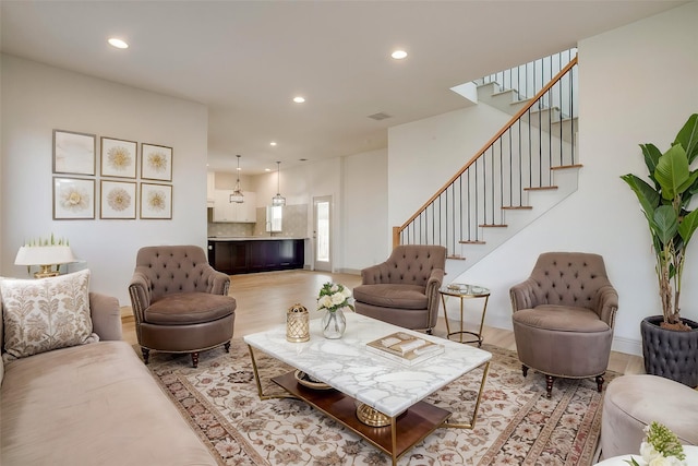 living room with sink and light hardwood / wood-style floors